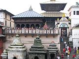 Kathmandu Pashupatinath 01 Pashupatinath Temple From Across Bagmati River The Pashupatinath Temple complex in Kathmandu on the banks of the holy Bagmati River is Nepals most important Hindu temple, and probably the holiest Hindu site outside India. Pashupati is one of the many names of Shiva, the most revered god in the Hindu pantheon, this one meaning the Lord of the Animals. Supposedly Shiva needed a holiday from Mount Kailash and chose the Kathmandu valley. Non-Hindus are not allowed to enter the temple. Below the Pashupatinath temple runs the Bagmati River, a holy river that eventually joins the Ganges. Pilgrims throw the holy water onto themselves, while a few hearty Hindus bathe fully.
